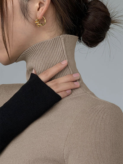 Asymmetrisches Patchwork-Strickoberteil mit langen Ärmeln und Stehkragen