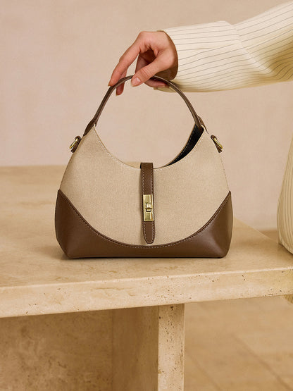 Farblich abgesetzte, knödelartige Tasche mit Metallverschluss